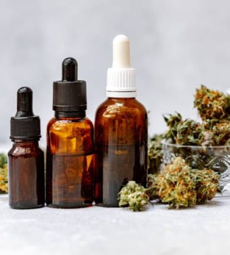 Cannabis herb and leaves with oil extracts in jars. medical concept, marijuana CBD oil hemp products.